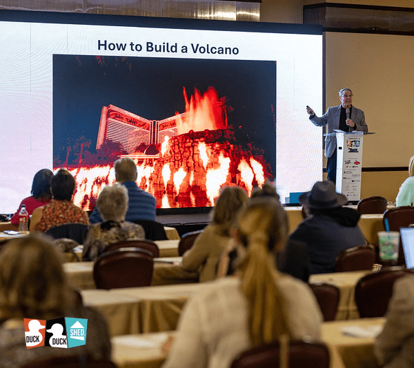 Person giving a presentation on building an artificial volcano